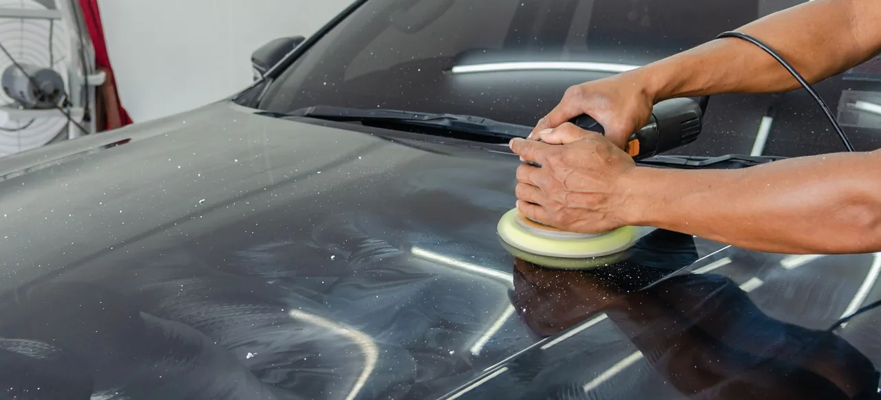 Machine polishing a car bonnet to remove swirl marks and restore gloss